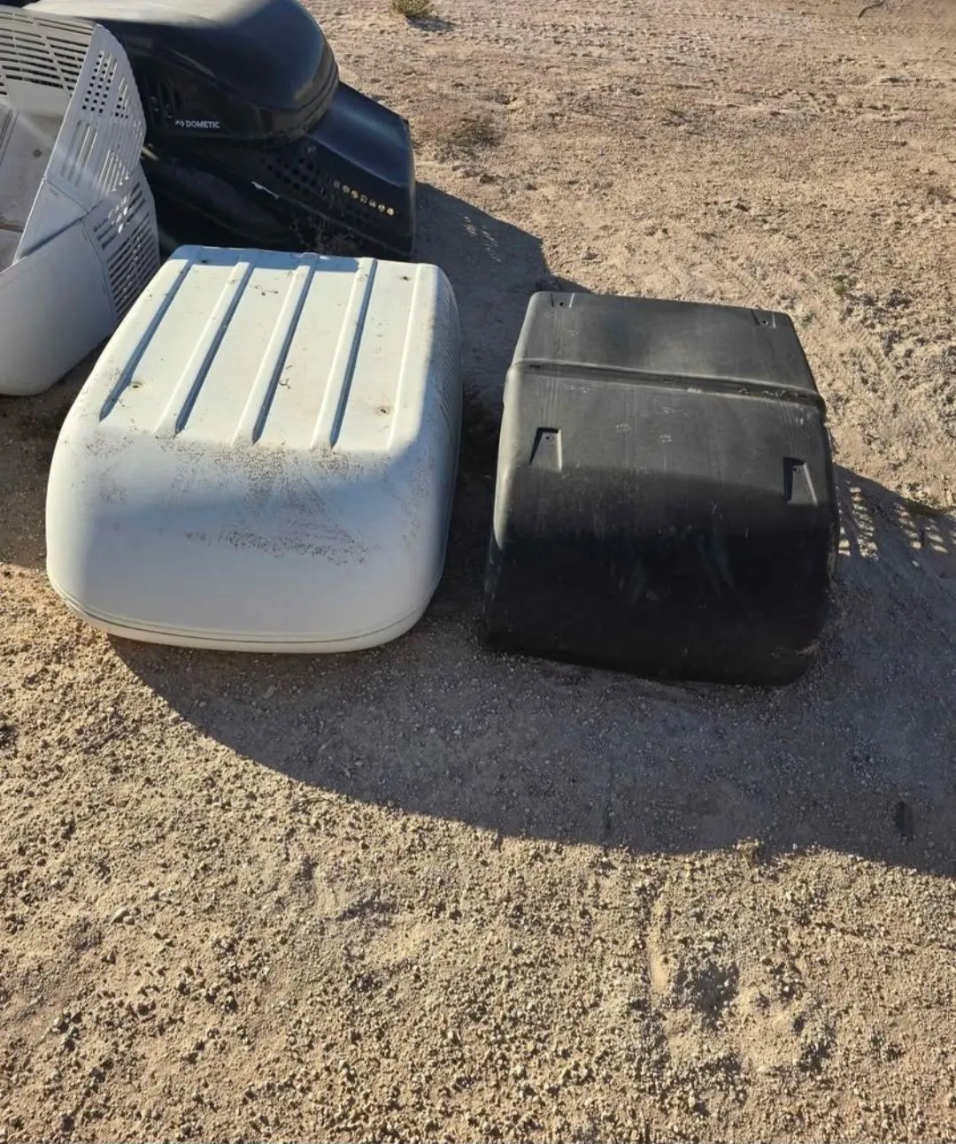 Salvaged RV air conditioner shrouds and covers in white and black